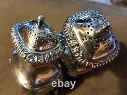 Antique sterling footed salt & pepper shakers with lions head, Birks, England
